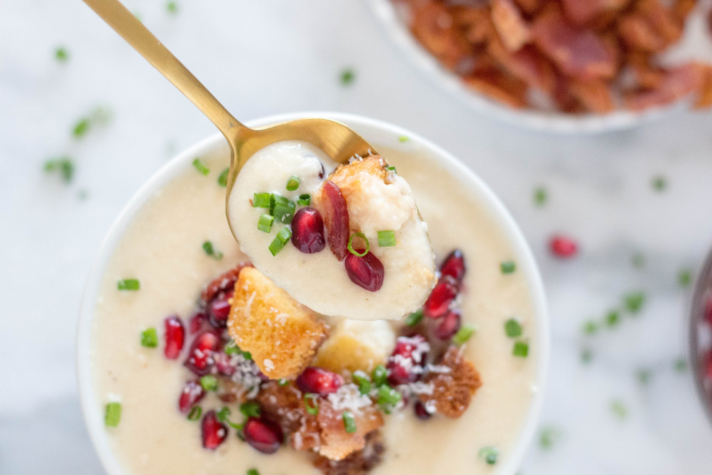 Creamy Parsnip Soup with Cornbread Croutons, Crispy Bacon, & Pomegranate Arils! It's perfect for serving buffet style at a holiday party! It's all about those toppings! | yestoyolks.com