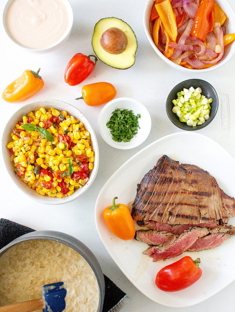Cheddar Rice Bowls with Marinated Flank Steak, Corn, & Chipotle Drizzle | yestoyolks.com