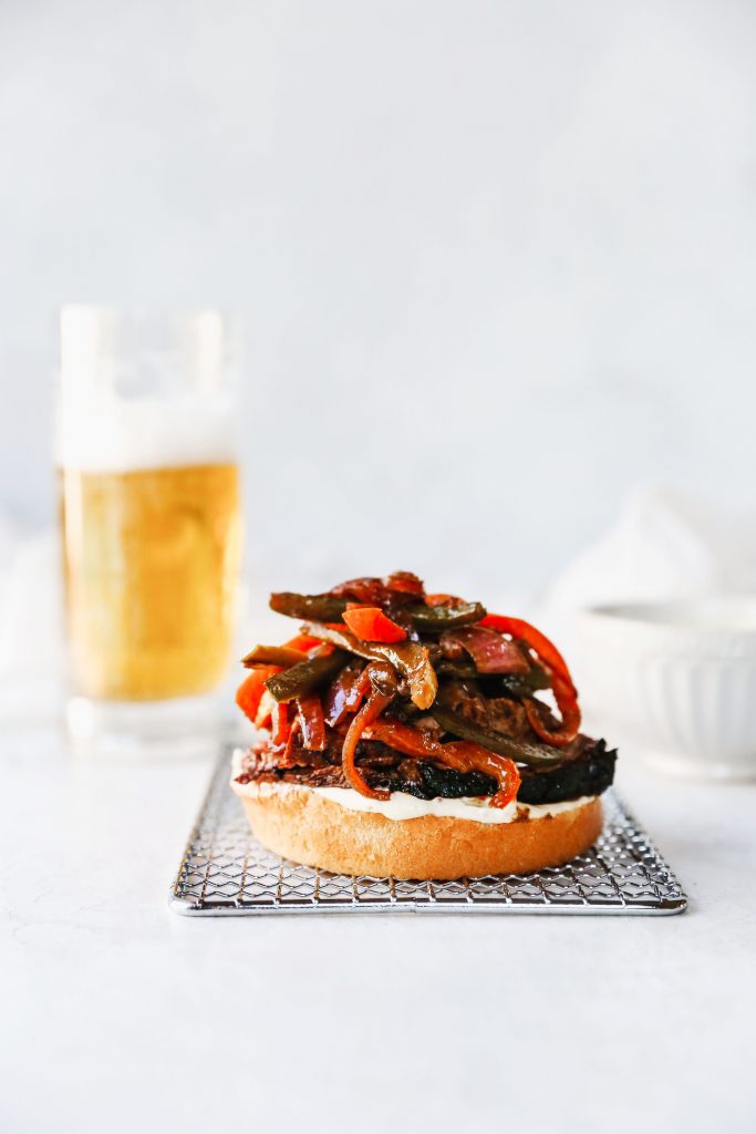 Guinness-Marinated Steak Sandwiches with Peppers, Onions, & Mustard Aioli